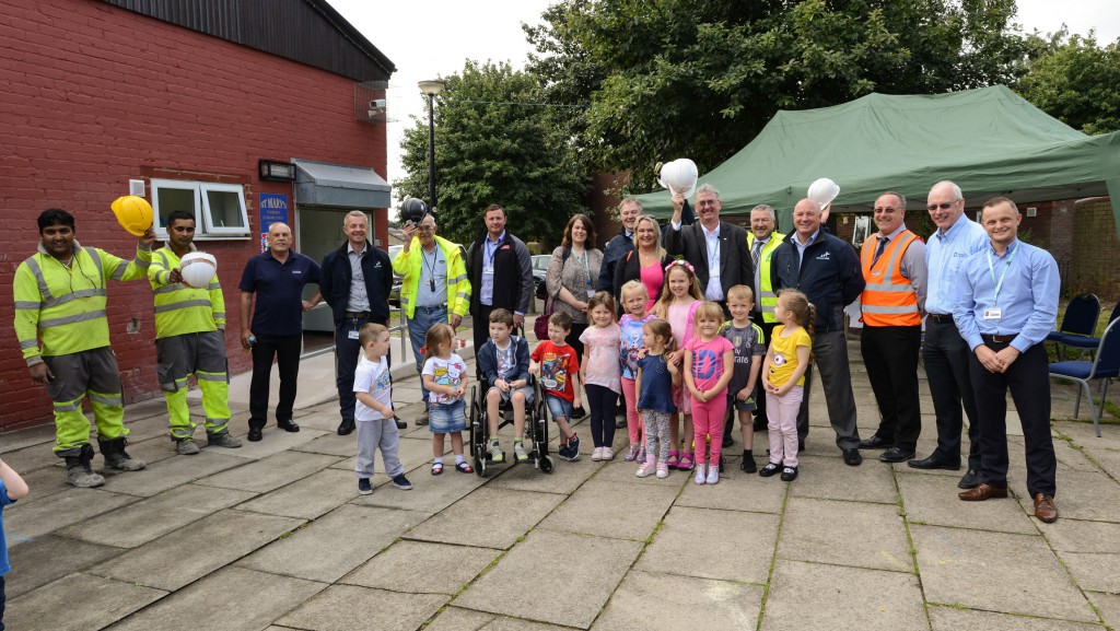 Staff from Merseylink, its subcontractors and West Bank Community Centre joining the children from Jiggys Childcare to celebrate the start of the construction of their new play area.